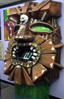 Hand-carved tiki-mask touchscreen kiosk built by TattooNOW, late 1990s